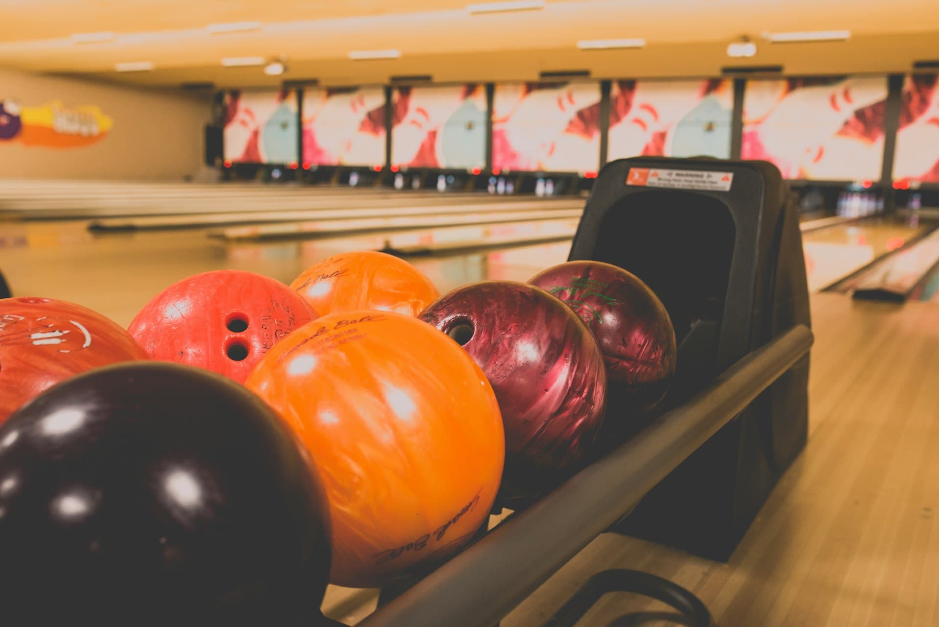 Bowling balls lined up on the return rack