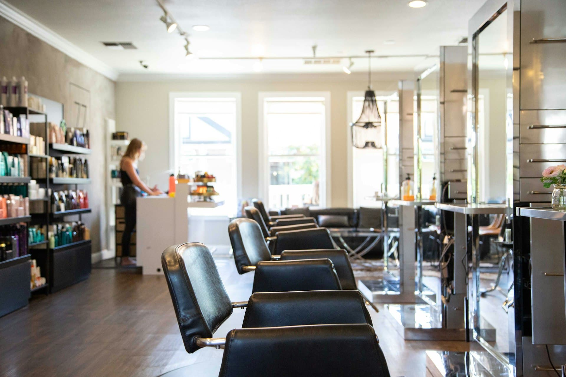 A salon with styling chairs and the front desk in daylight